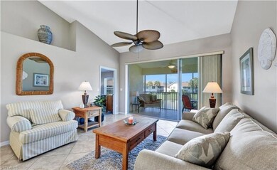 Tiled living room featuring ceiling fan and lofted