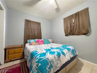 Bedroom featuring ceiling fan and light tile patte