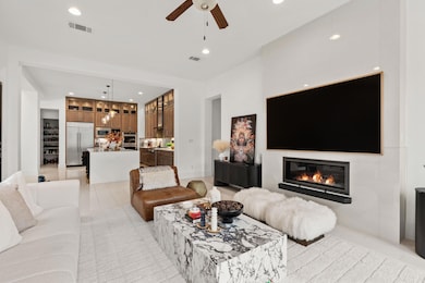Living room featuring a glass covered fireplace, 