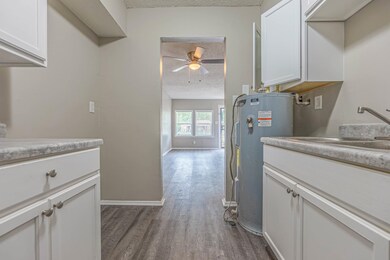 Washroom with ceiling fan, a textured ceiling, dar