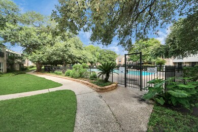This photo showcases a serene community area featuring a well-maintained walking path, lush greenery, and a gated swimming pool, perfect for leisurely strolls and relaxation.