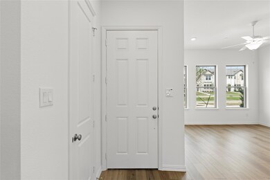 Foyer with ceiling fan and hardwood / wood-style flooring