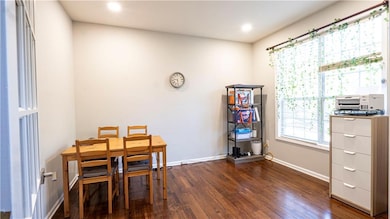 Dining space featuring dark wood-style floors and recessed lighting