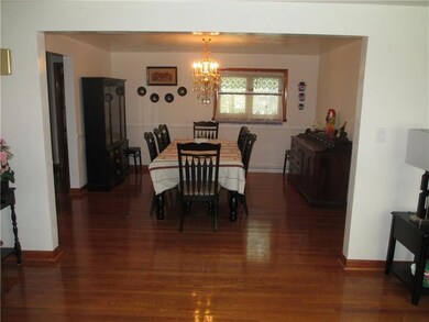 An expansive formal dining room awaits, adorned wi