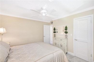 Bedroom featuring light colored carpet, ceiling fa