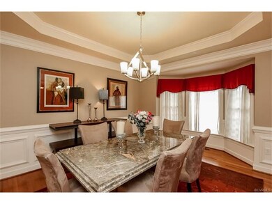 Formal dining room showcases wainscoting, tray cei