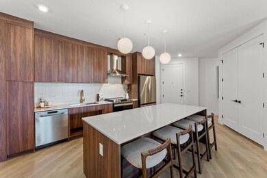 Kitchen with light wood-type flooring, wall chimn