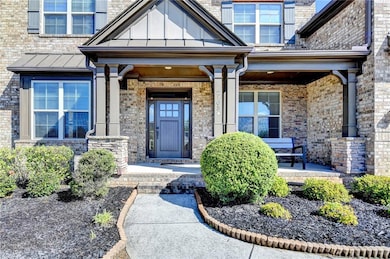 Entrance to property featuring a porch, metal roof