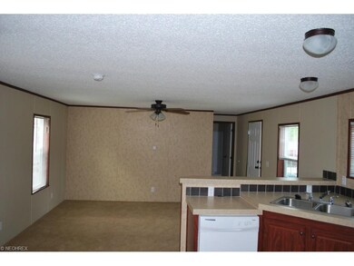 Kitchen opens to living room.