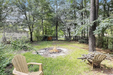 Fenced backyard featuring a fire pit