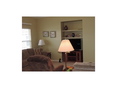 Living room with vaulted ceiling, built in area fo