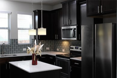 Kitchen featuring appliances with stainless steel