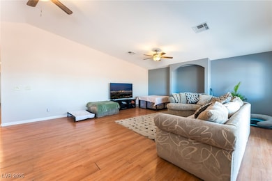 4656 E DI Living area with a ceiling fan, vaulted