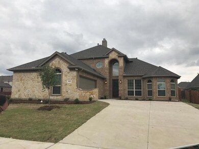 French country home with a garage and a front lawn