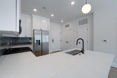 Kitchen with stainless steel fridge with ice disp