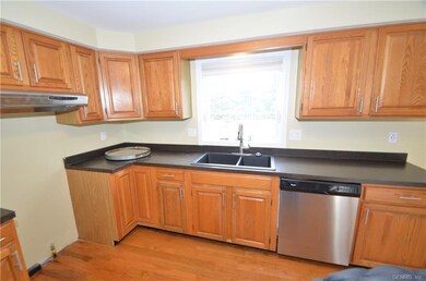 Oak eat in kitchen featuring hardwood floors