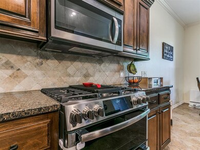Kitchen with light tile floors, ornamental molding