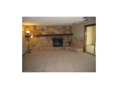 Lovely family room with stone accents and a firepl