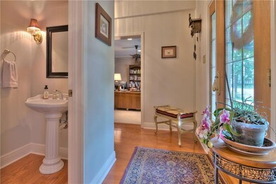 view from dining into foyer, powder room and livin