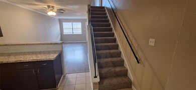 Stairway featuring baseboards, ceiling fan, orname