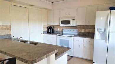 kitchen with a stone backsplash, lrg pantry and sl