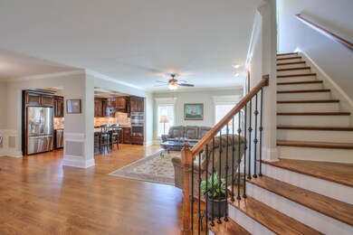 Wrought iron spindles, hardwood stairs, graceful turn with landing.  Such nice details.