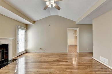 Unfurnished living room featuring visible vents, a