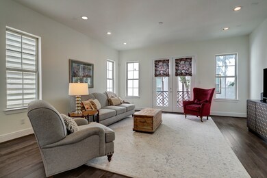 With ample windows and neutral walls, the living r