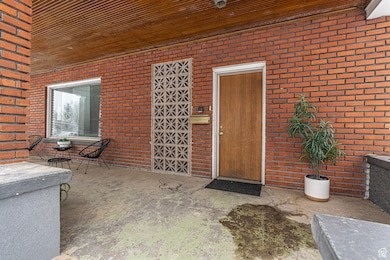 View of exterior entry with brick siding