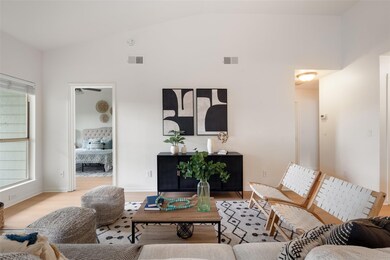 Living area with wood finished floors, high vault