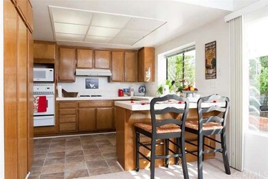 Cheerful bright kitchen has well kept cabinets and