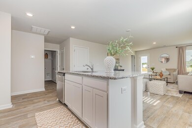 Kitchen featuring light stone countertops, a sink,
