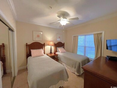 Carpeted bedroom featuring crown molding, ceiling 