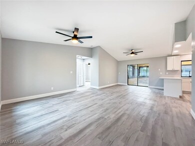 Unfurnished living room with ceiling fan, light wo
