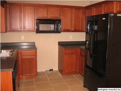 Kitchen with nice cabinets,microwave and refrigera