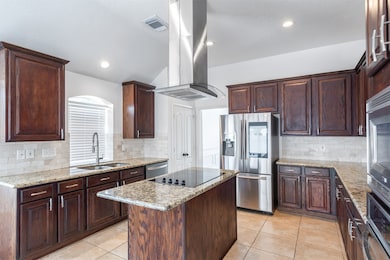A bright and spacious kitchen with an island and modern appliances, seamlessly connected to the dining area, providing a perfect space for family meals and entertaining guests.