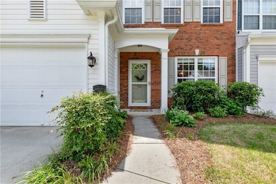 View of exterior entry with brick siding and an at