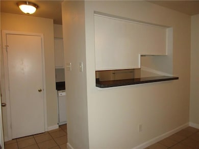 Hallway featuring light tile patterned flooring