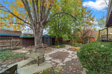 Fenced backyard with a patio and a storage unit