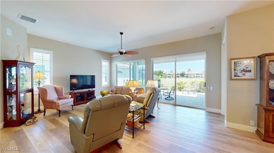 Living room featuring light wood finished floors and a ceiling fan