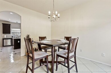 Formal dining with view to the kitchen entrance.