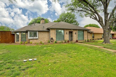 Single story home with brick siding, a front lawn,