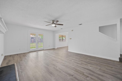 Unfurnished living room with ceiling fan, a textu