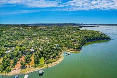 Drone / aerial view of a large body of water and a heavily wooded area
