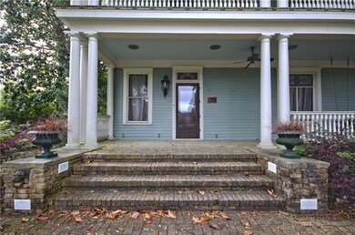 Bricked front porch with tons of outdoor lighting 