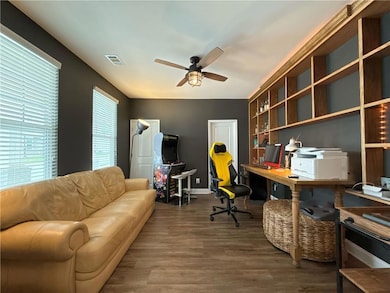 Office area featuring a ceiling fan and wood finished floors