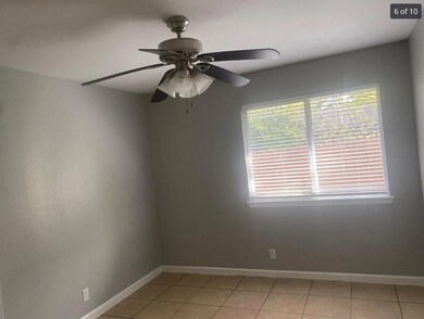 Spare room with baseboards, a ceiling fan, and li