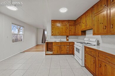 Kitchen featuring backsplash, white gas range, sin