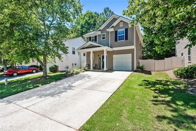 Traditional-style home with driveway, a porch, and a garage