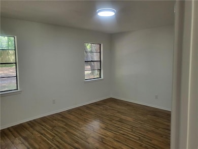 Bedroom 2 dark wood-style floors and baseboards